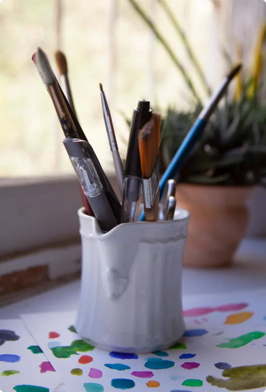Greeting card layouts and paintbrushes in the studio